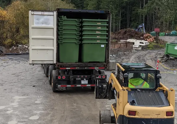 New green commercial garbage bins being unloaded at the Salt Spring Garbage yard
